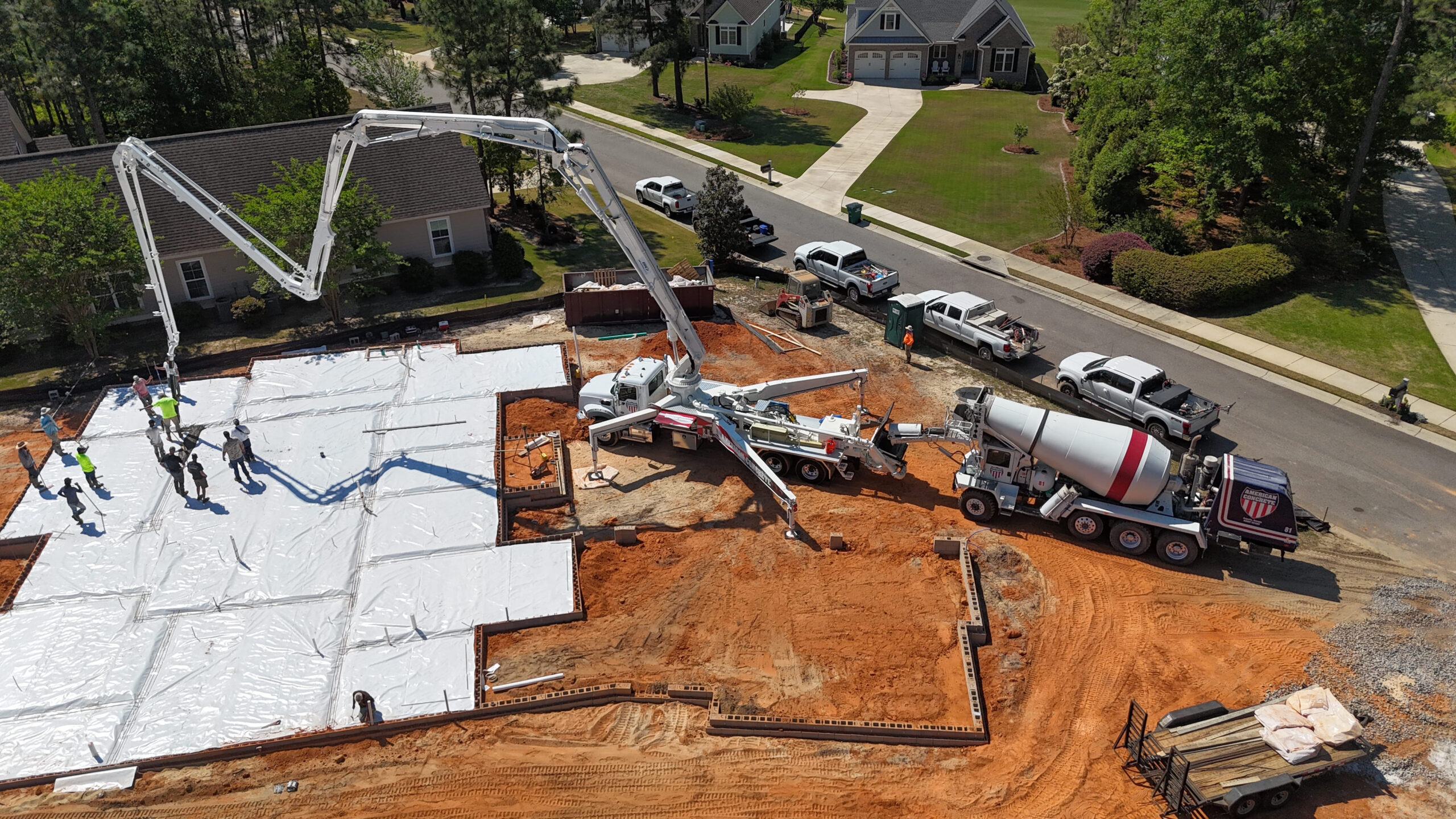 American Concrete 40-meter boom pump placing concrete on a residential foundation