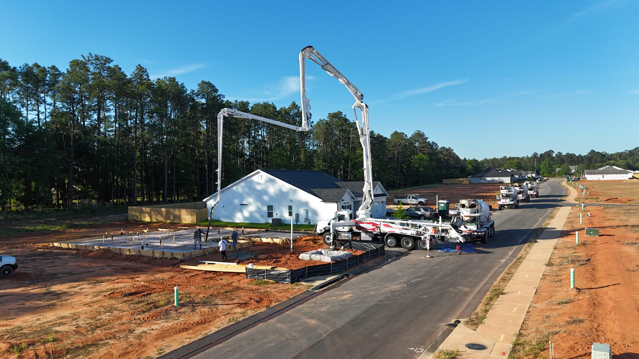 Concrete pump boom extended over a job site